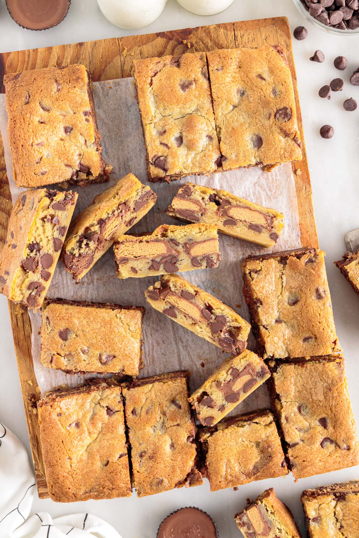 Top close view of peanut butter cup cookie bars on cutting board.