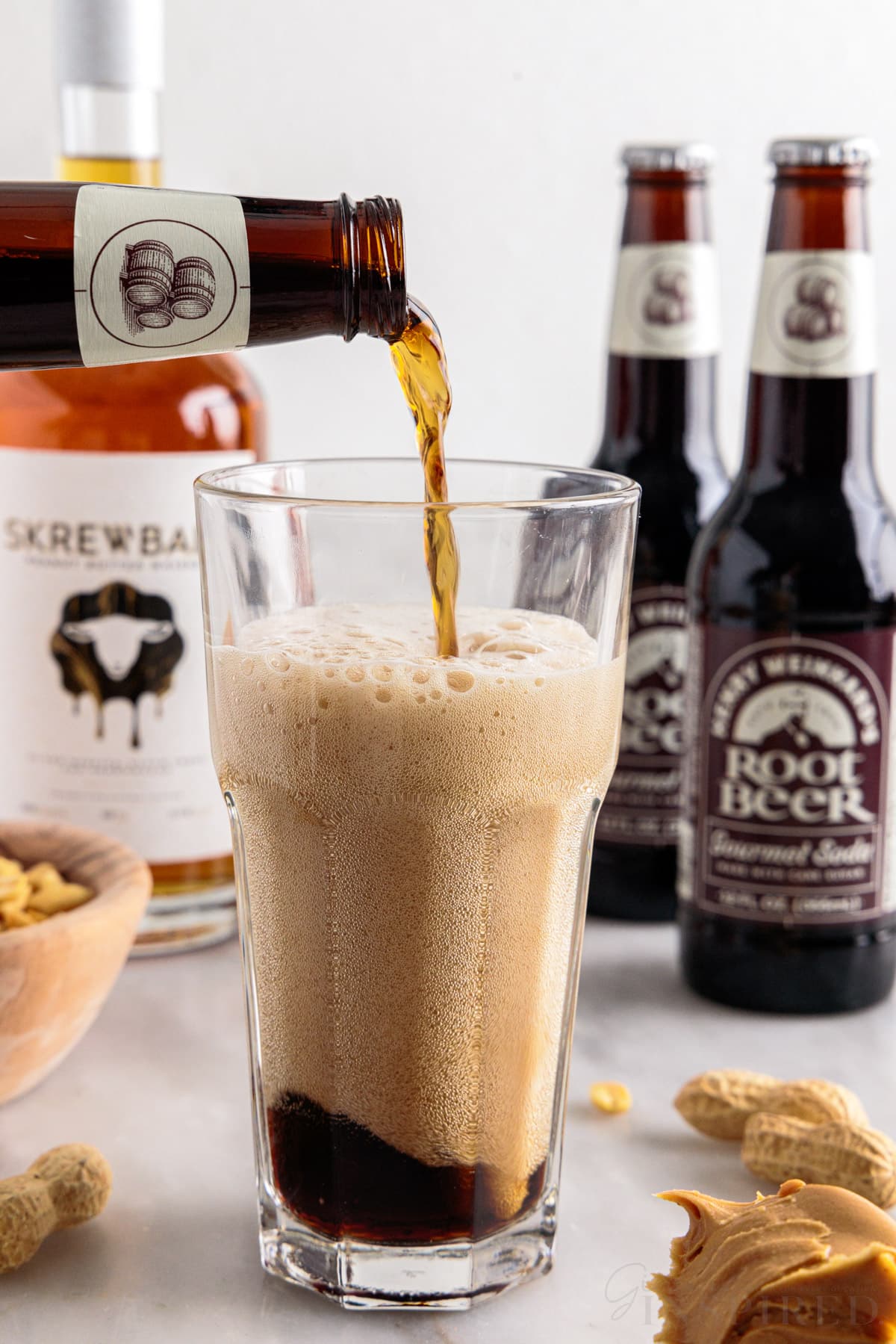 Root beer poured into a tall glass.