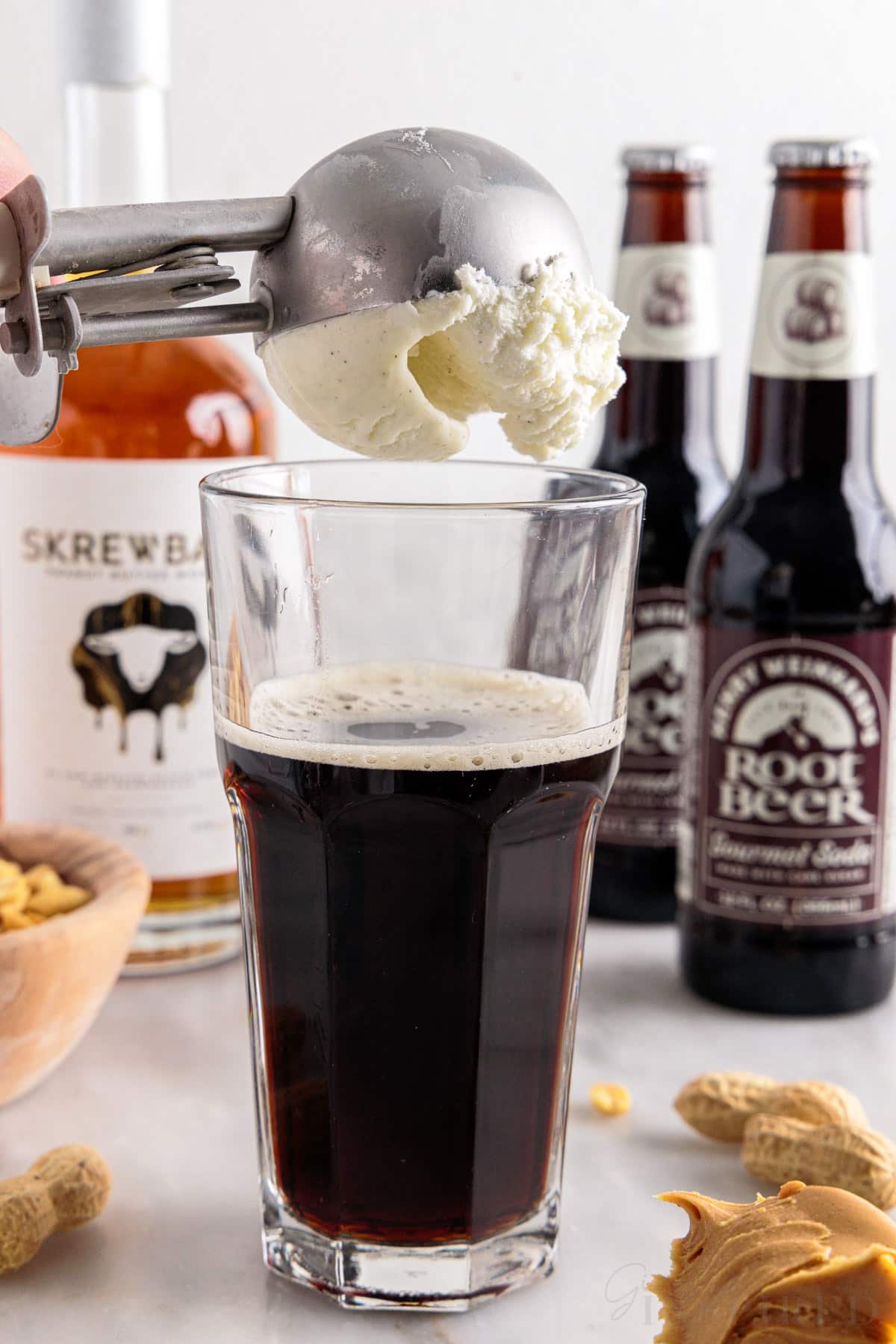 A scoop of ice cream added to the whiskey and root beer.