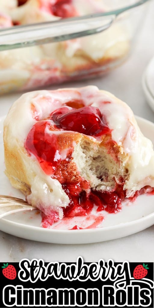 Strawberry cinnamon roll on a plate with a bite taken out.