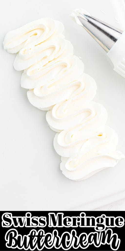 Close-up of piped Swiss meringue buttercream with piping nozzle on a white plastic board, on a marble countertop.