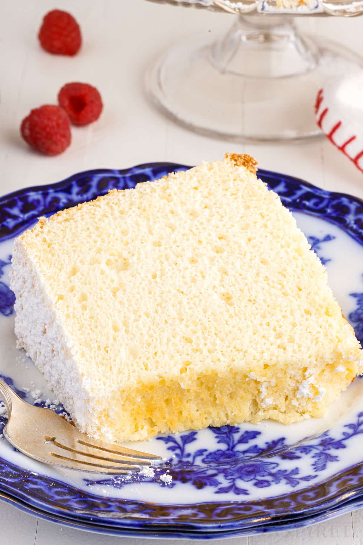 A plain slice of Vanilla Chiffon Cake on a decorative plate.