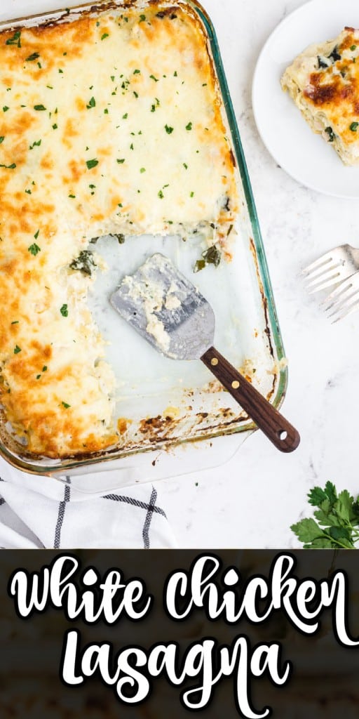 Overhead shot of baked white chicken lasagna in a glass baking dish with a serving removed, on a marble countertop.