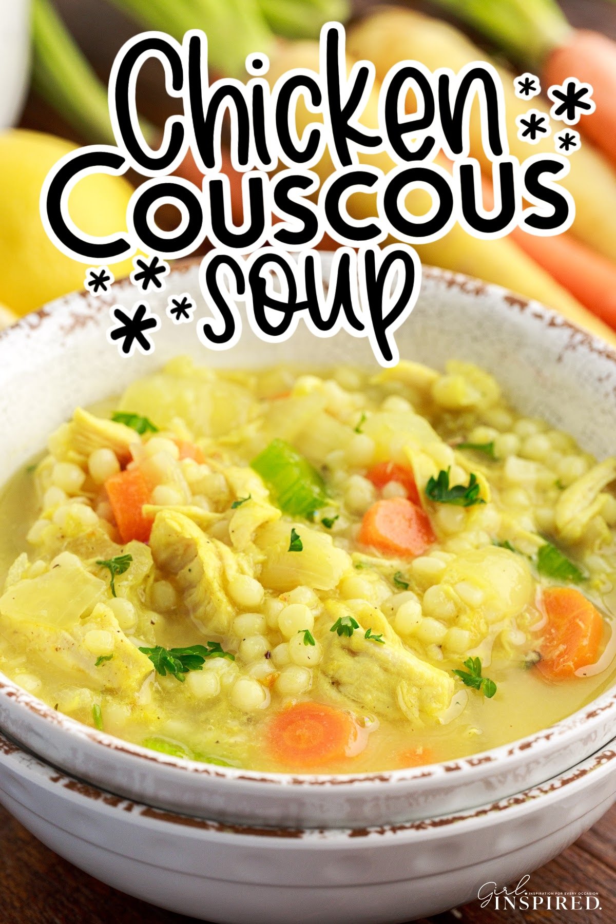 Stack of bowls with chicken couscous soup, colorful carrots and lemons in background and text title overlay.