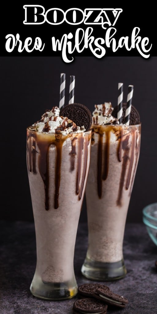 Two Boozy Oreo Milkshakes with whipped cream topping and Oreo cookie garnish and black and white straws in each.