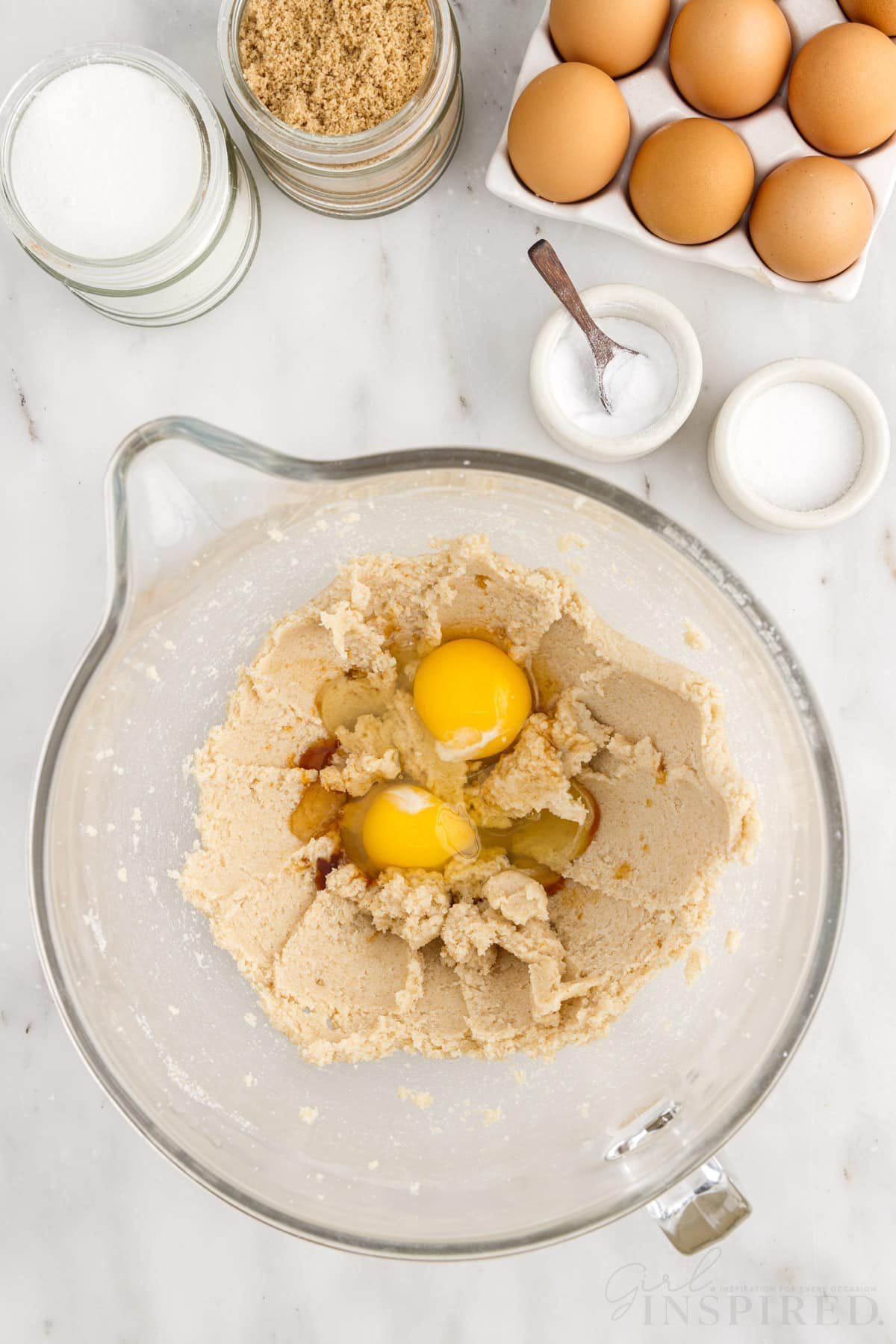 Eggs added to the sugar mixture next to eggs, and sugars.