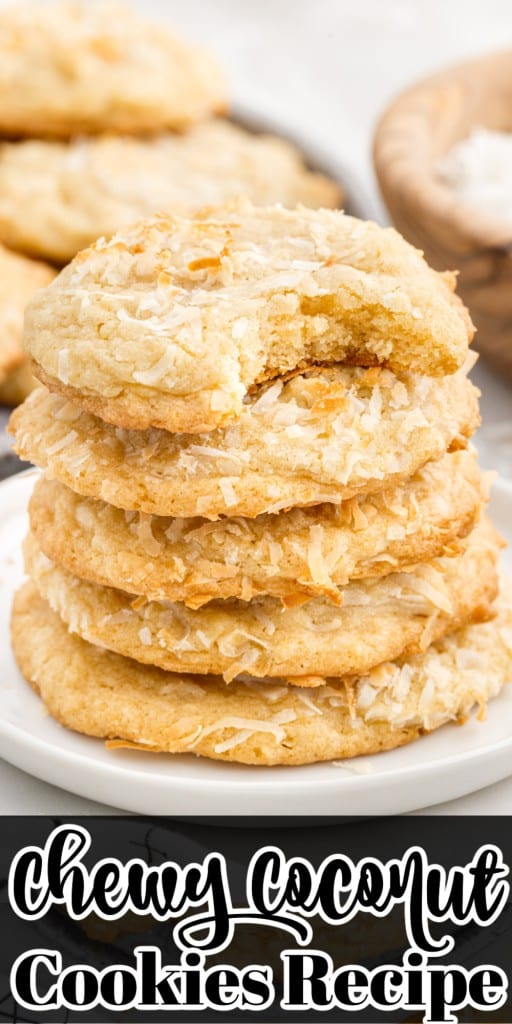 A small dish with four Chewy Coconut Cookies stacked on top of each other with a bite missing from the first one and a plate of them in the background.