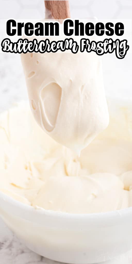 Cream cheese buttercream frosting in a mixing bowl, frosting on a plastic spatula held above the mixing bowl.