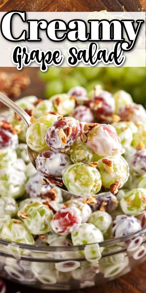 Spoonful of creamy grape salad lifted from serving bowl.