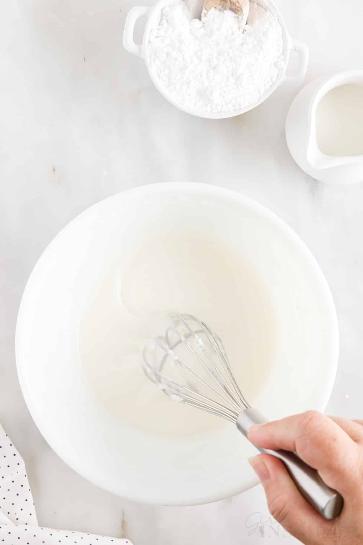 Duncan Hines Lemon Cake glaze in mixing bowl with whisk.