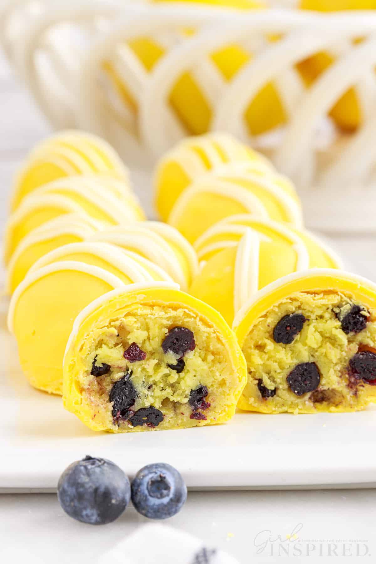 Cut open lemon blueberry bite with thick cake filling and blueberries exposed.