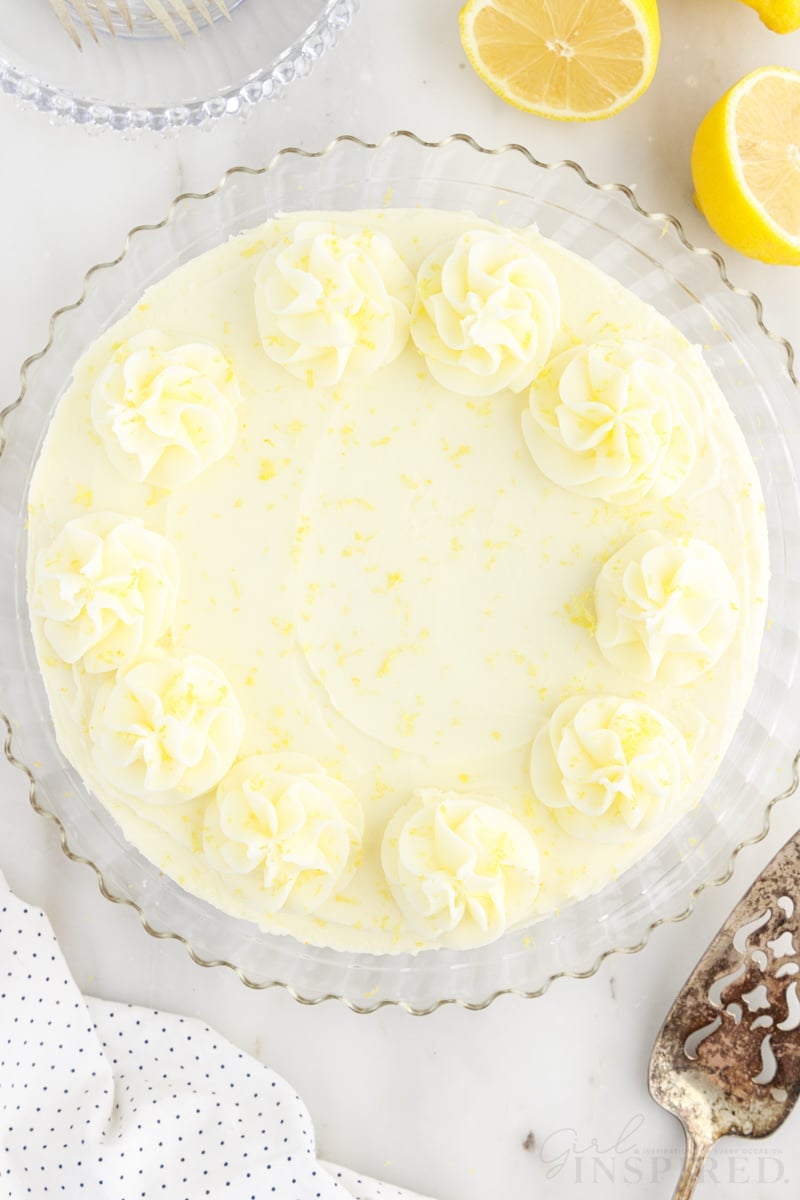 Top view of a Lemon Layer Cake with lemons next to it.