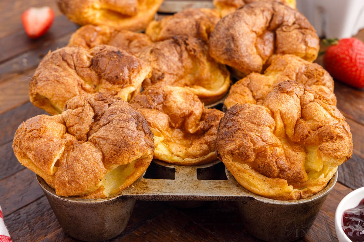 Front view of baked popovers in a popover pan.