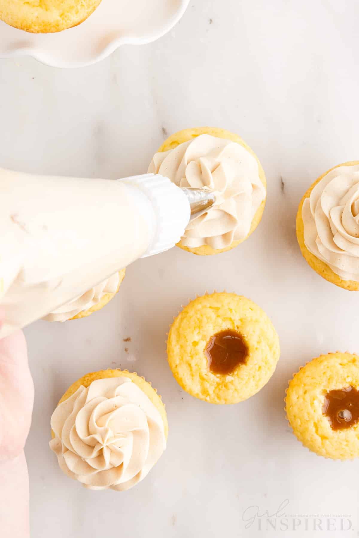 Piping bag frost Salted Caramel Cupcakes.