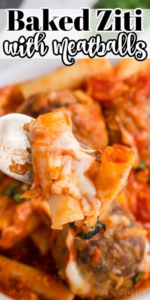 close up of baked ziti with meatballs in a skillet with forkfull of it held above the skillet