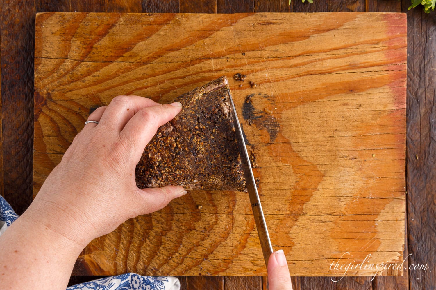 Tenderloin on cutting board being sliced.