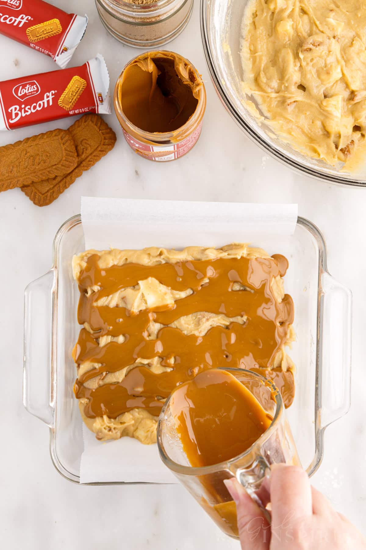Melted cookie butter poured on top of Biscoff Blondies batter.
