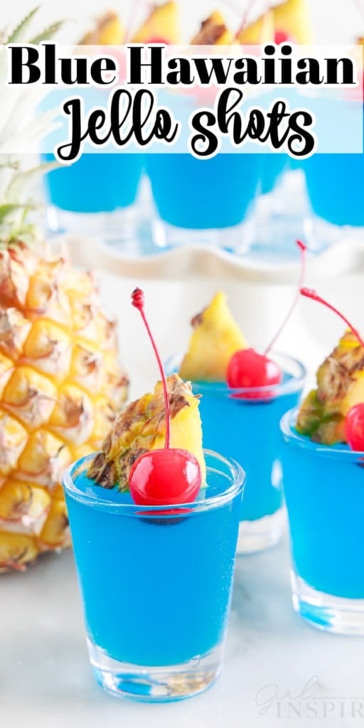 Blue Hawaiian Jello Shots on the counter and a tiered tray with a pineapple.