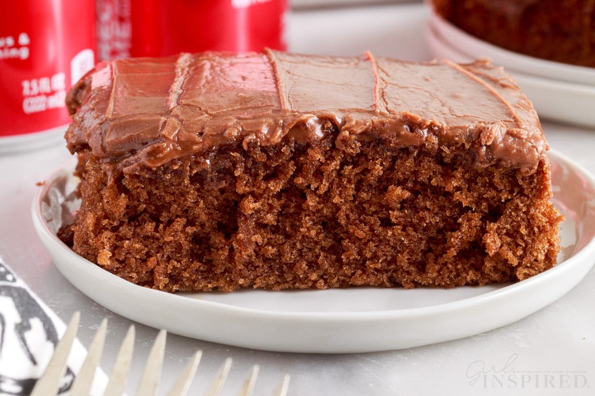 Close up side view of a slice of Coca Cola Cake on a small plate.