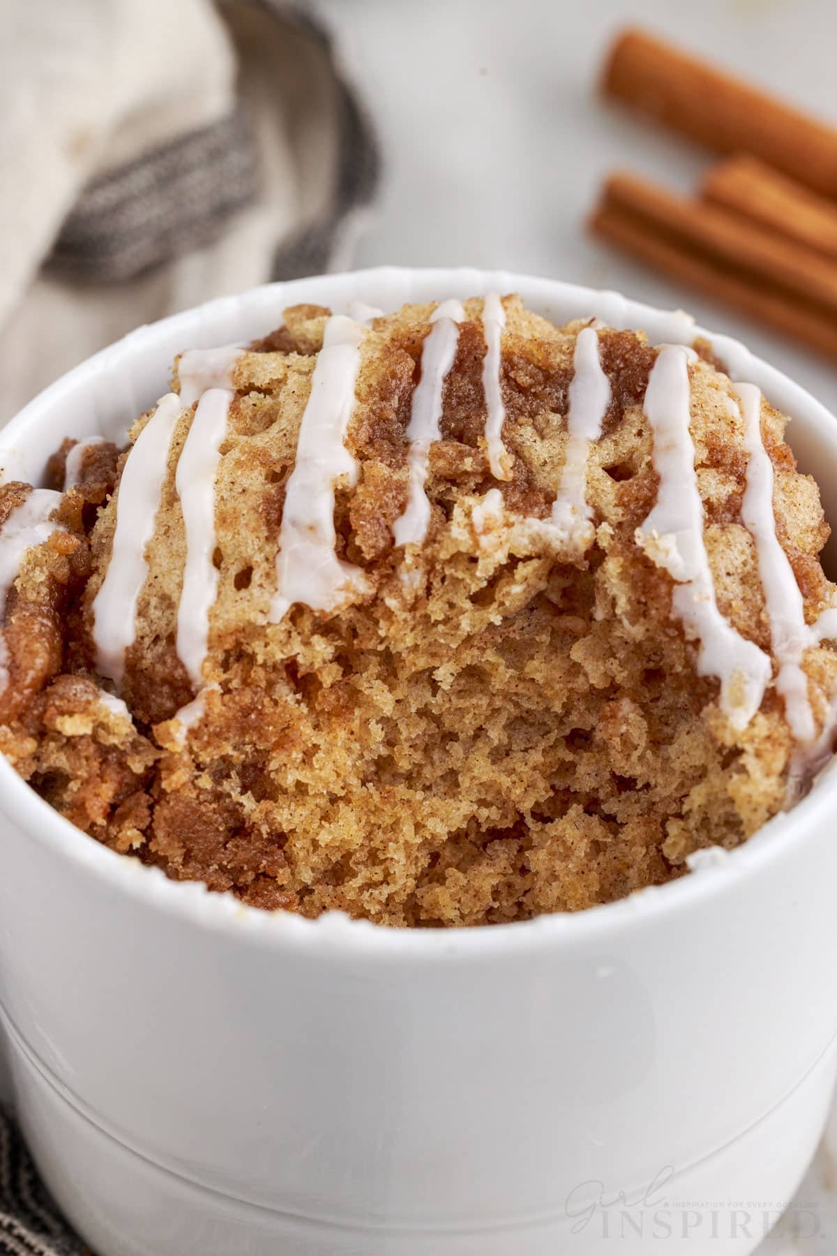 Front view of Coffee Cake in a Mug with a bite taken from it.