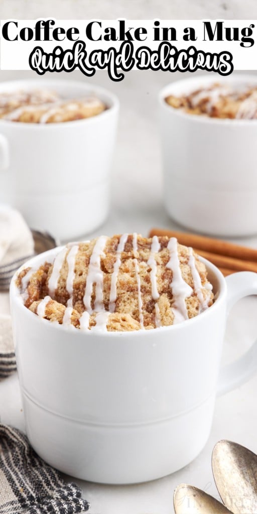 Front view of coffee cakes in mugs with close up of one mug cake and two others in the background along with some cinnamon sticks, spoons and a linen cloth on the side on a white countertop