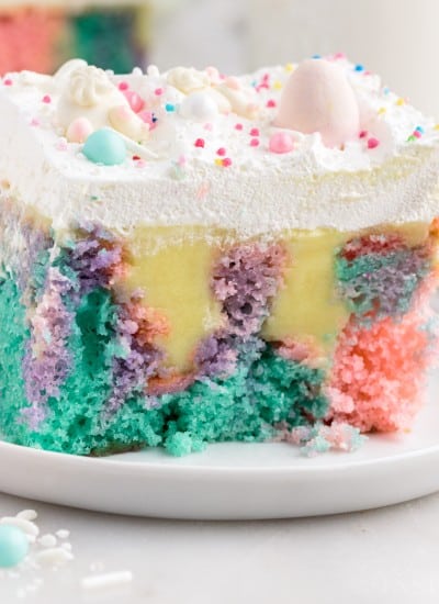 Close up of a slice of Easter Poke Cake on a small dish.