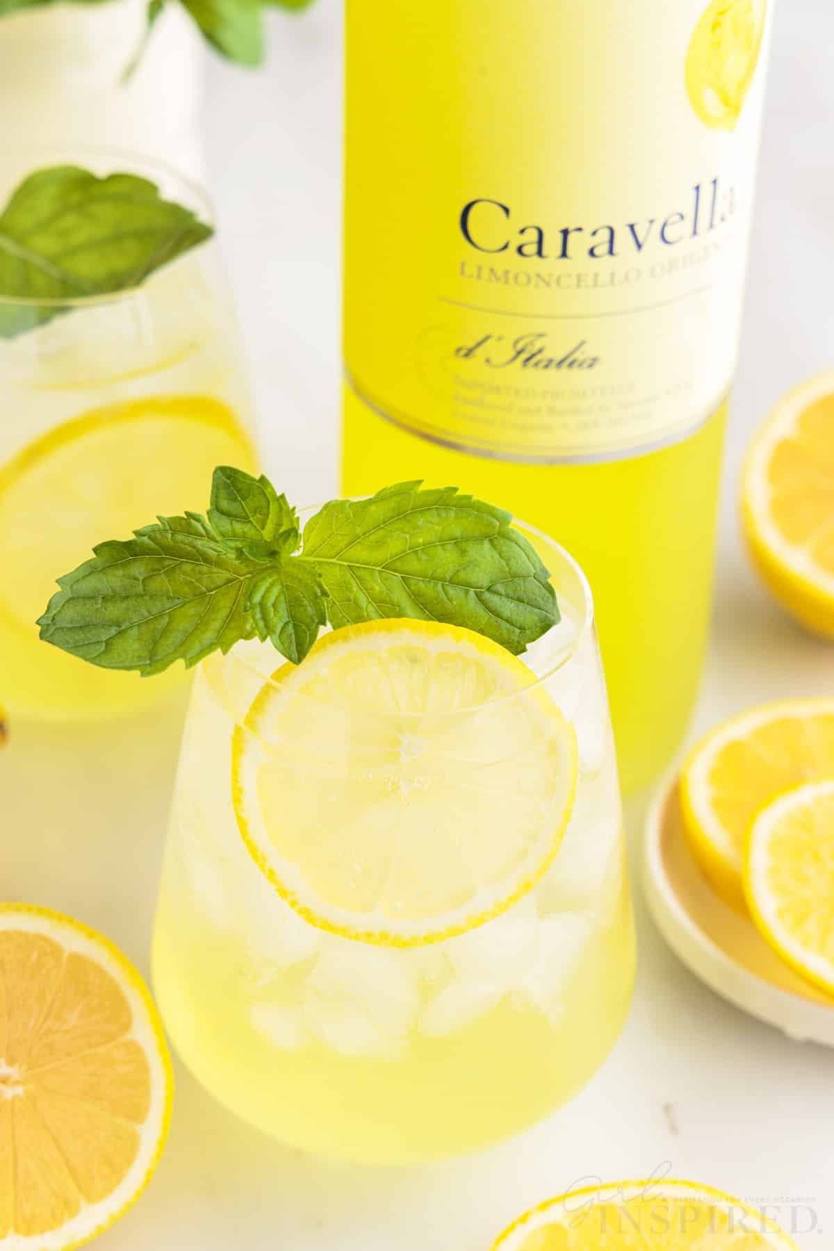 Limoncello Spritz and a bottle of Limoncello with lemon slices.