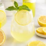 Close up of a glass of Limoncello Spritz with lemon slice and fresh mint.