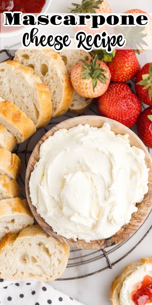 Overhead view of a dish of Mascarpone Cheese next to sliced bread and strawberries.