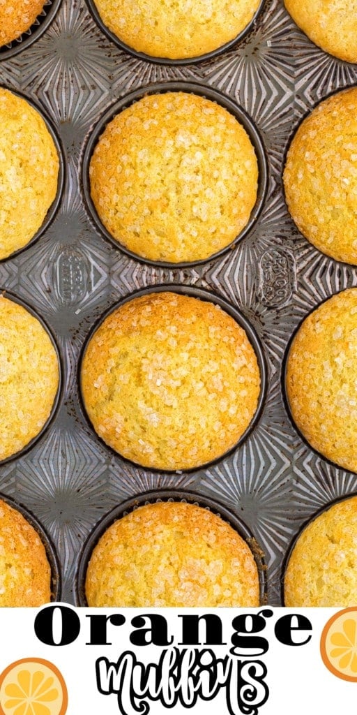 Close-up of baked orange muffins in a metal muffin tin.