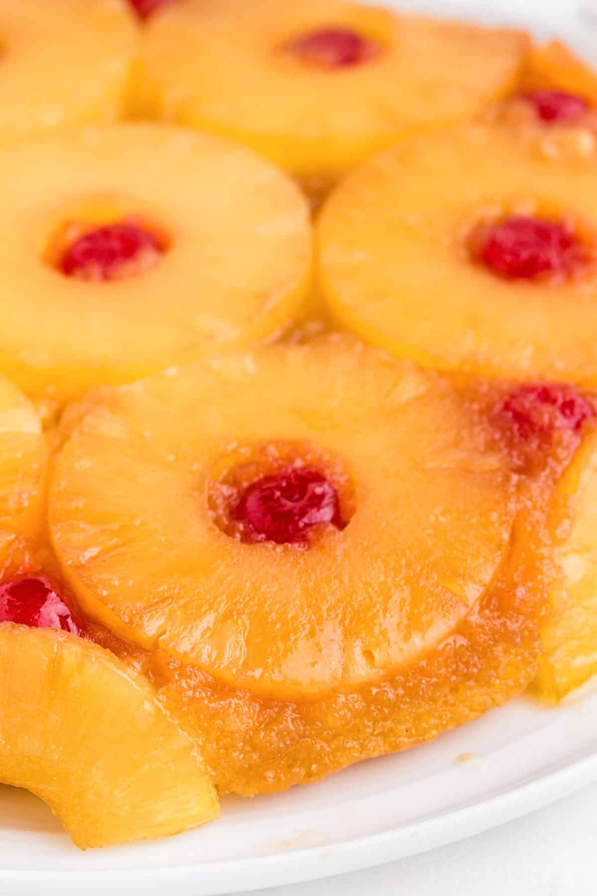 Close-up of pineapple upside down cake recipe using cake mix on a white marble countertop.