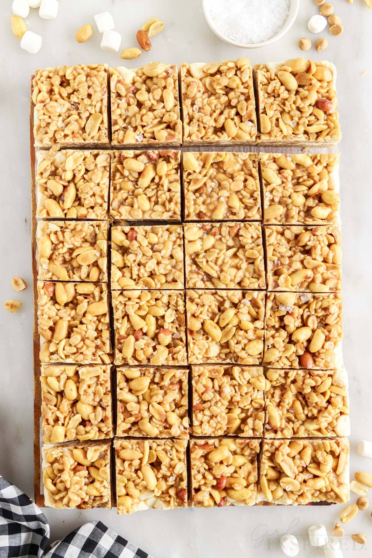 Salted Nut Roll Bars cut into squares on a cutting board.