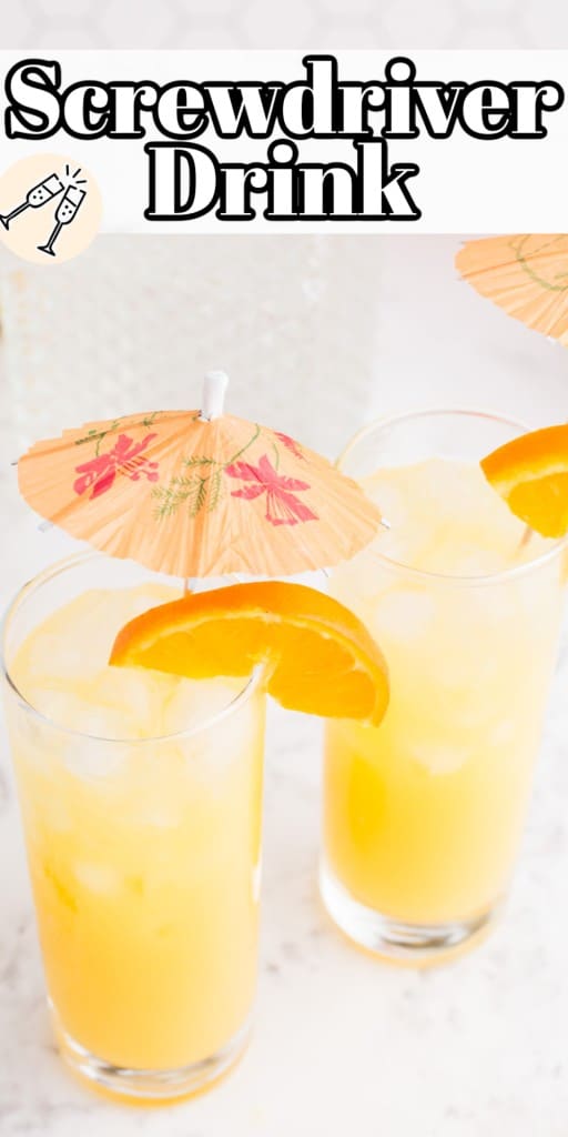 Close-up for two glasses of screwdriver drink with orange slices and decorative drinks umbrellas.