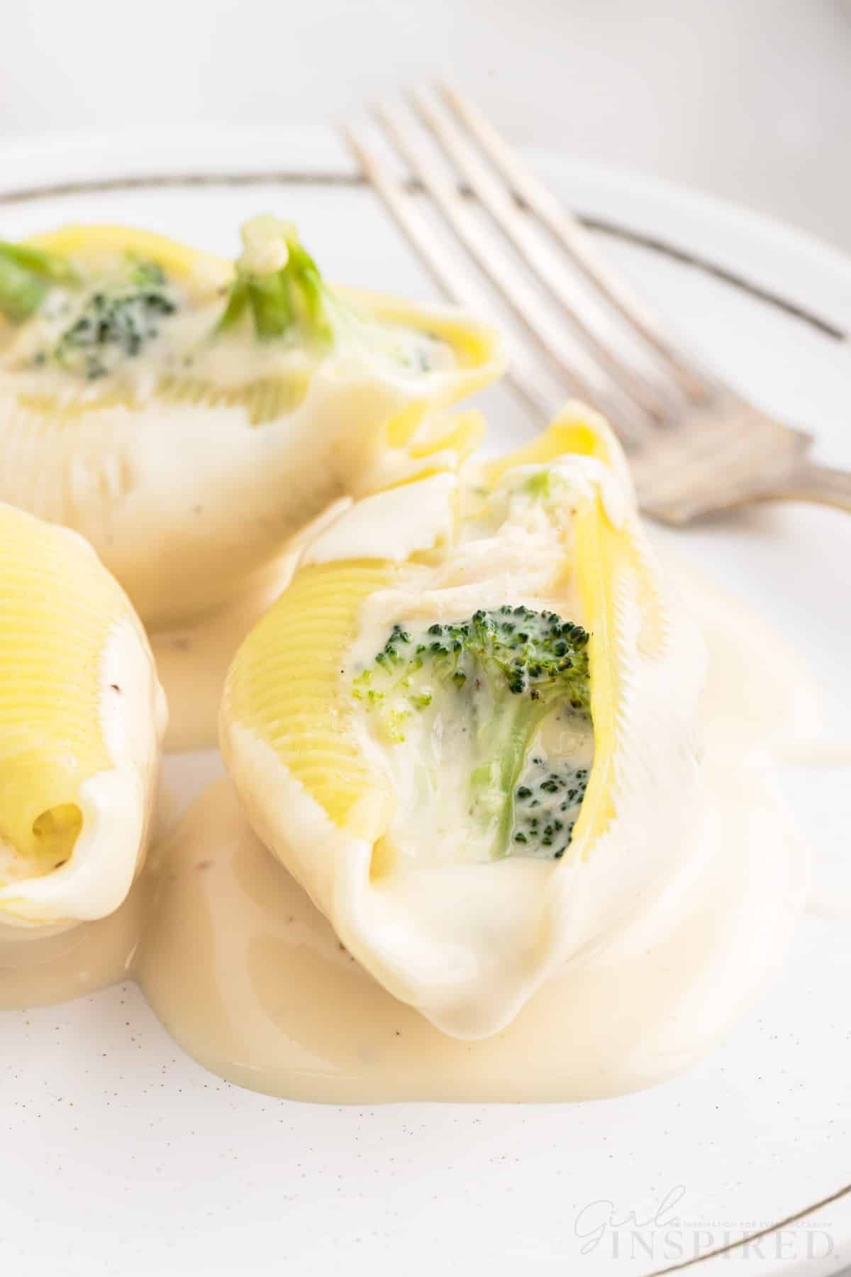 Chicken Alfredo Stuffed Shells on a plate with a fork.