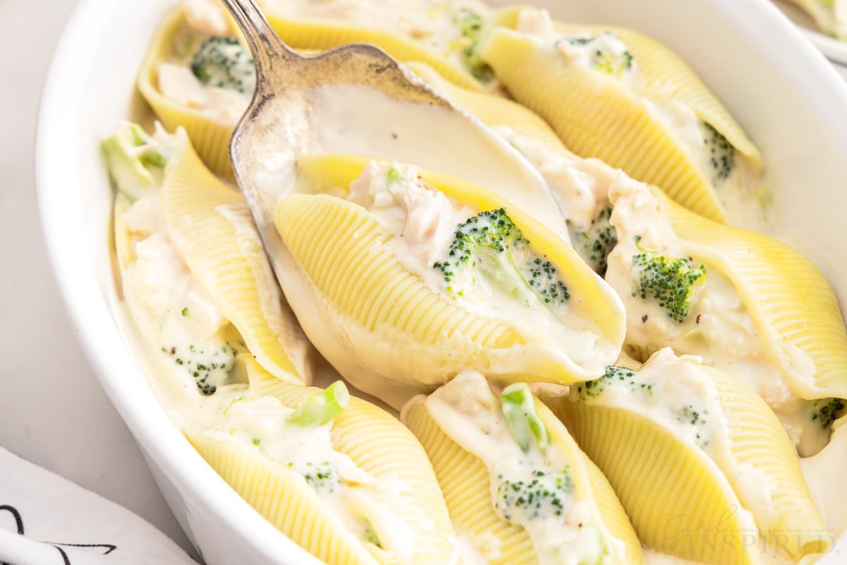 Close up of Chicken Alfredo Stuffed Shells one on a spoon.