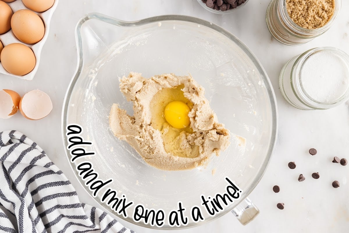 Egg added to brown sugar mixture in a mixing bowl with text overlay to add and mix one at a time.
