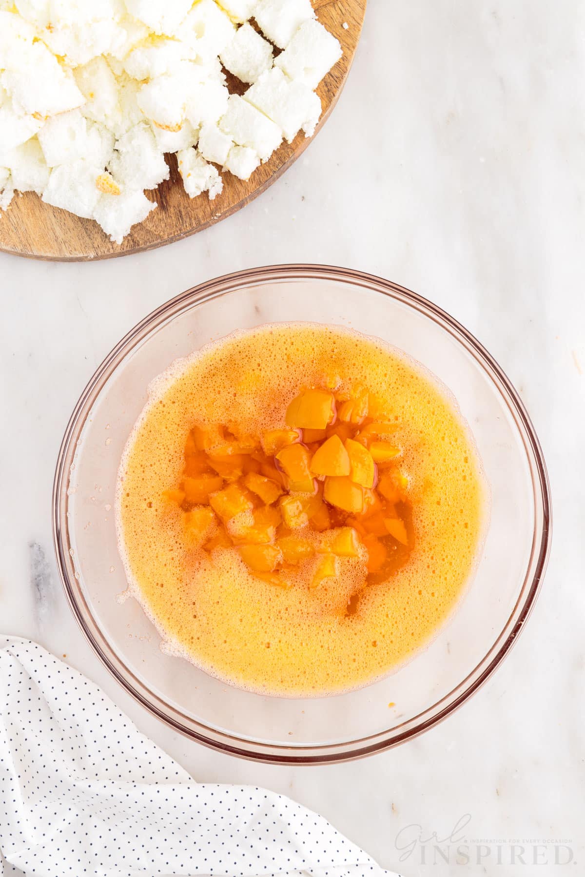 Apricots added to gelatin mixture in a mixing bowl to make Apricot Delight.