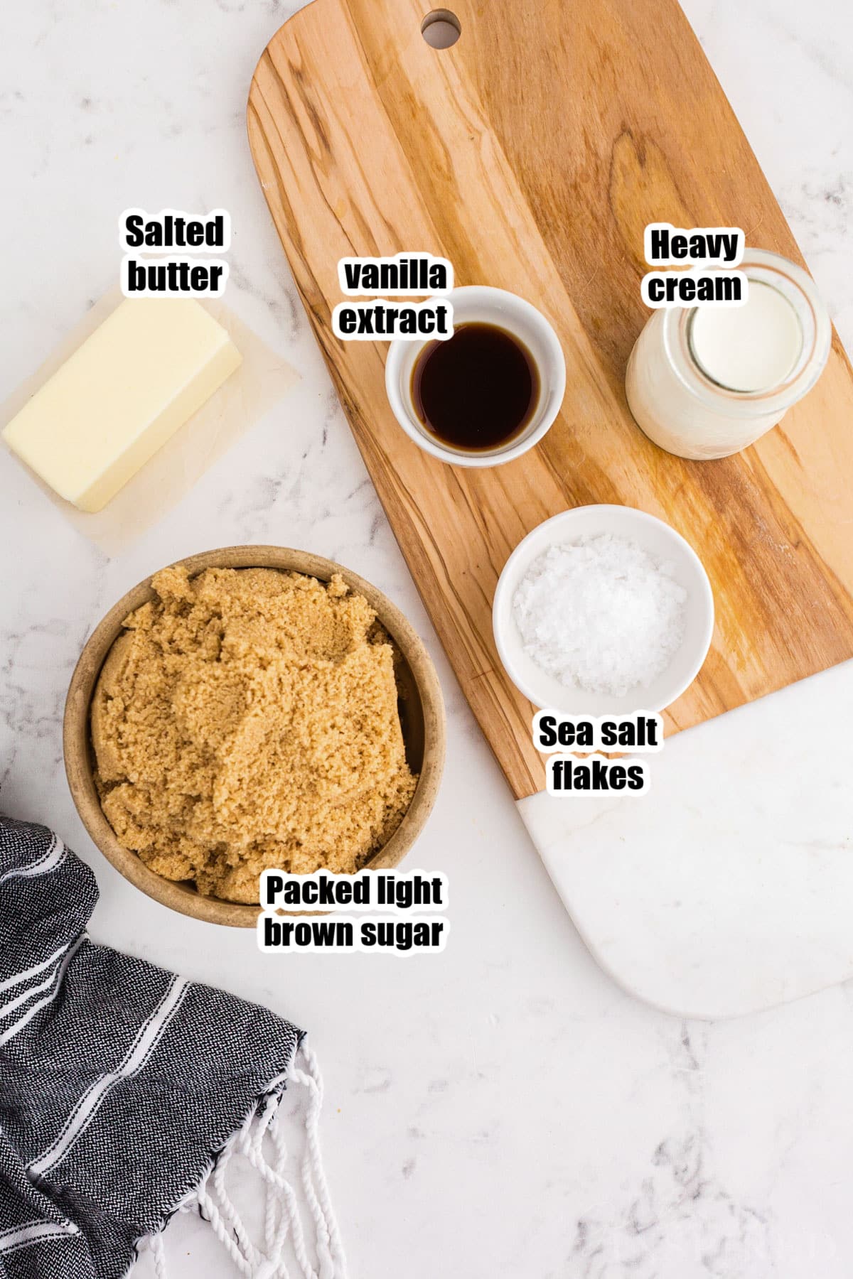 Overhead view of brown sugar caramel sauce recipe ingredients on a marble countertop.