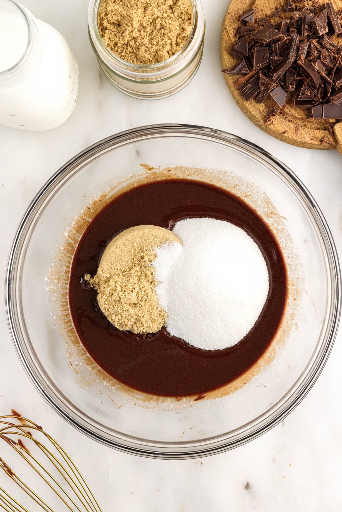 Sugars added to chocolate mixture in a mixing bowl for Edible Brownie Batter.