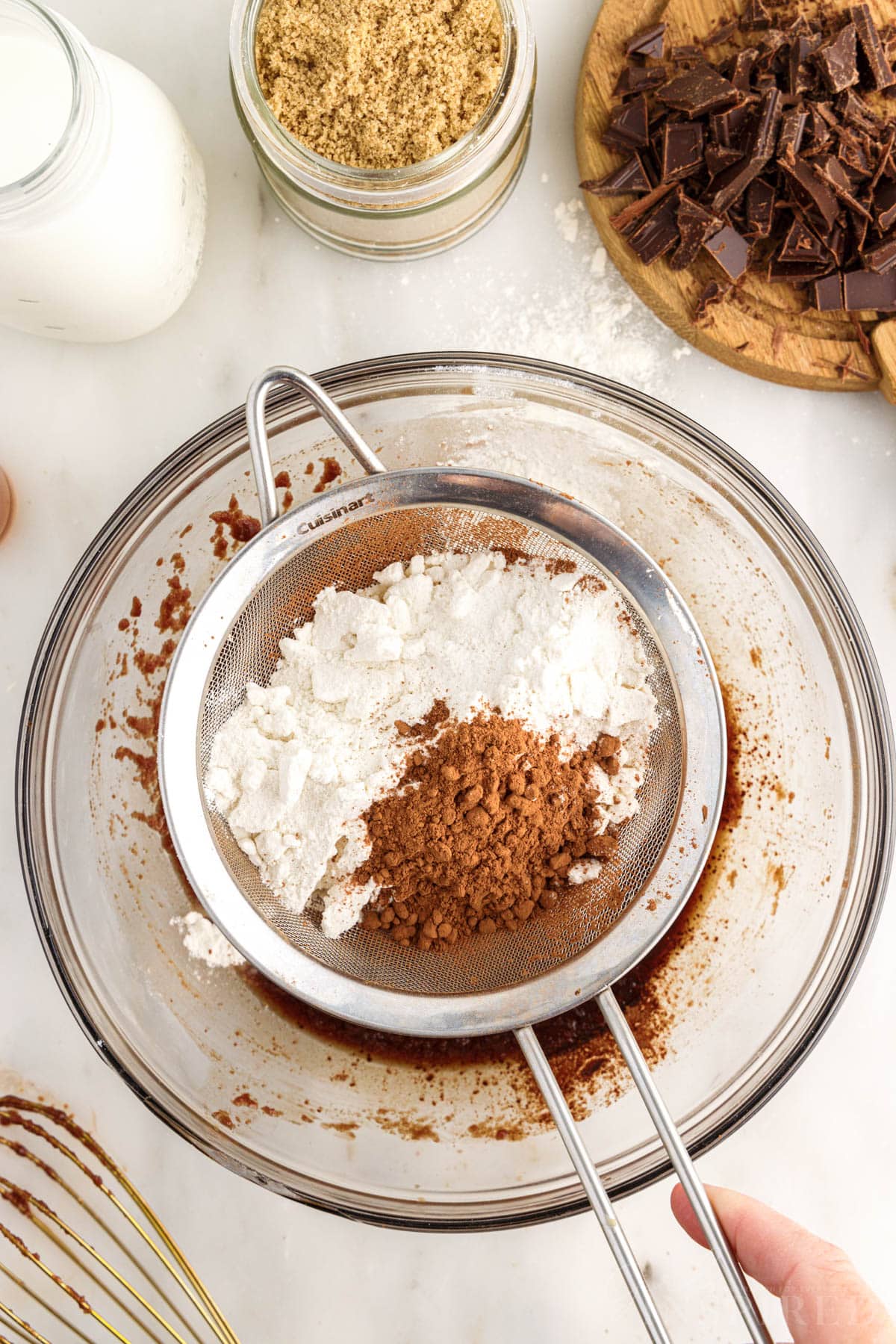 Cocoa powder and flour in a sifter above Edible Brownie Batter.