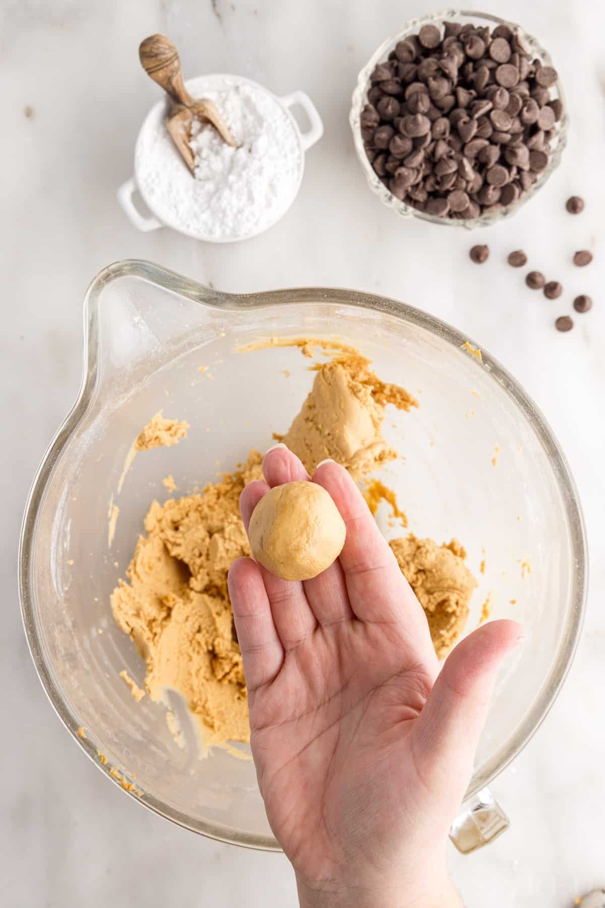 Buckeye Balls rolled into a ball over Buckeye Balls dough.