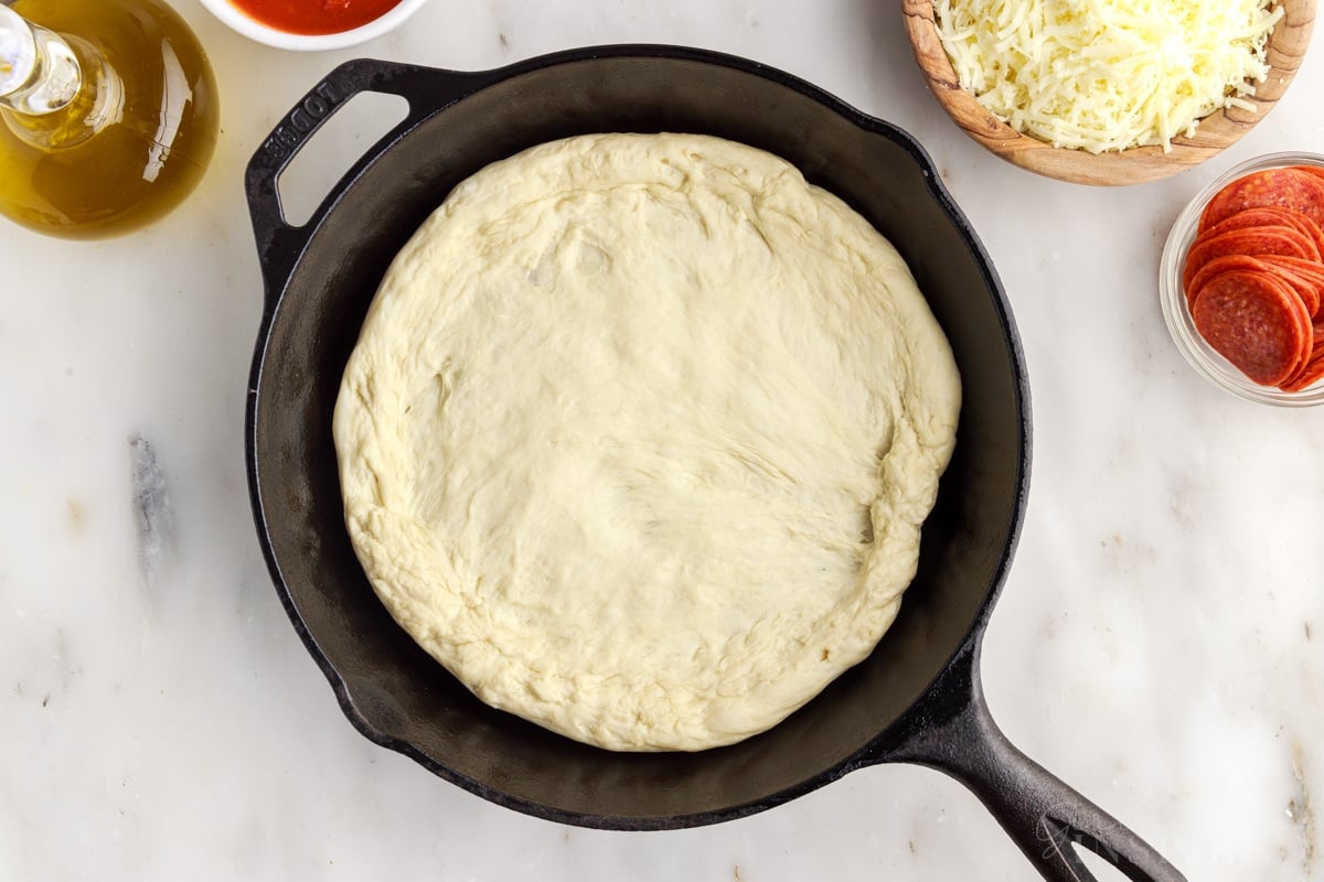Dough pressed out into cast iron skillet.