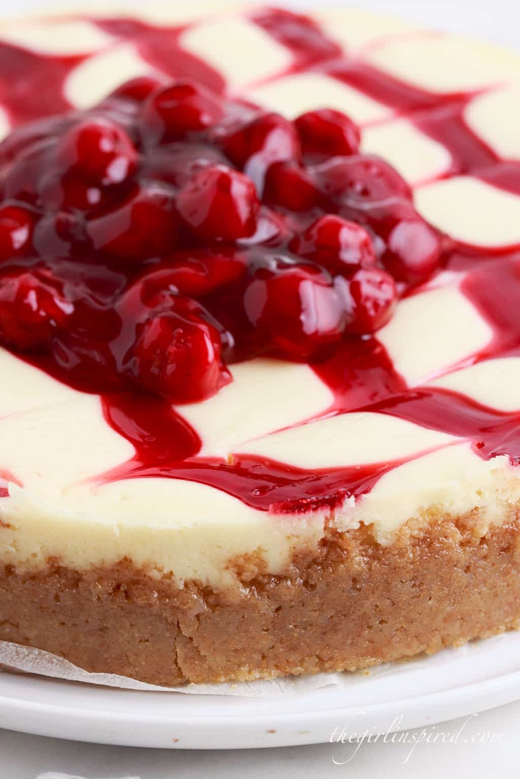 Front view of Cherry Cheesecake on a plate with cherry topping.