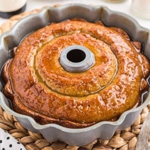 Close up of freshly baked and glazed crack cake in a bundt pan.
