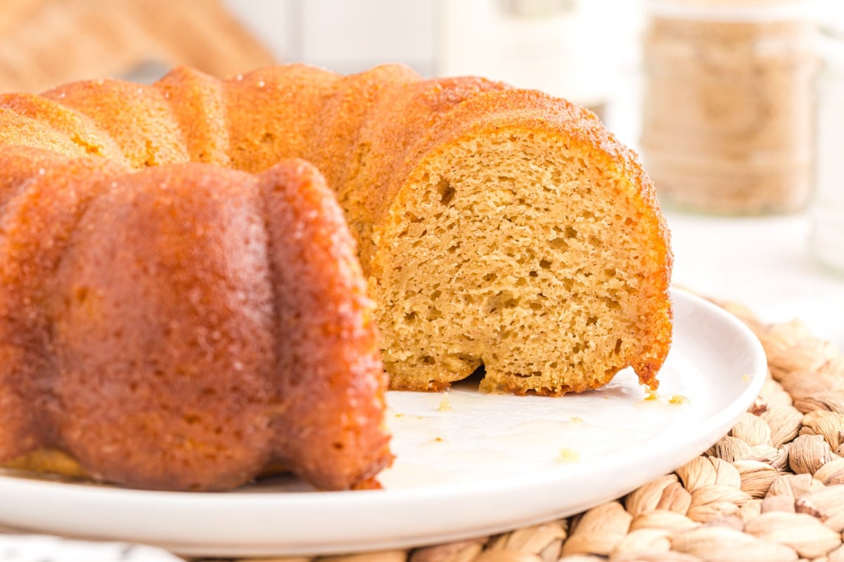 Close up of backed and sliced crack cake on a white cake plate.