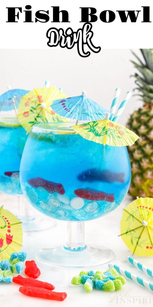 Drink umbrellas added to goblets of Fish Bowl Drinks with a pineapple in the background