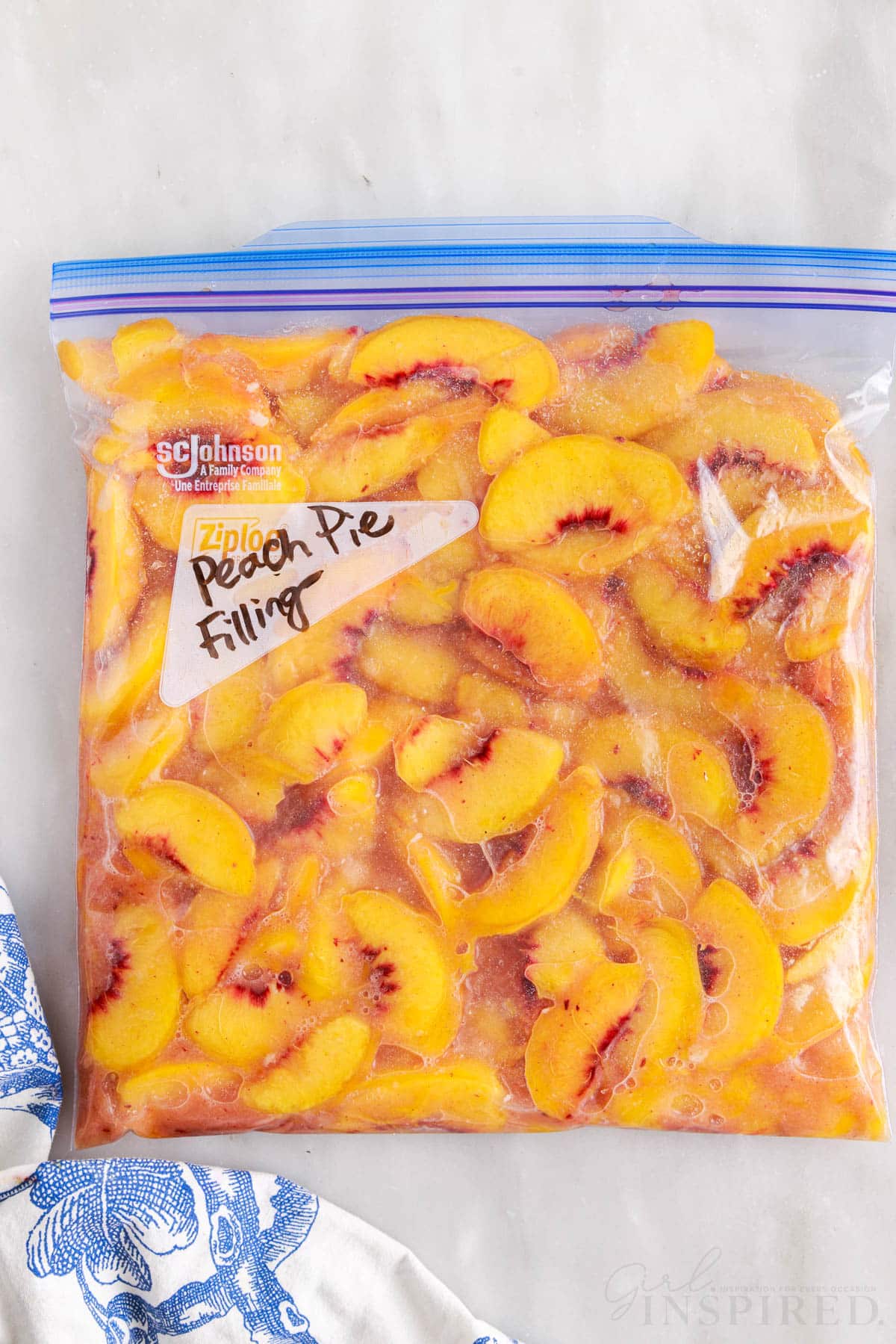Sliced peaches in a gallon freezer bag zipped and lying down.