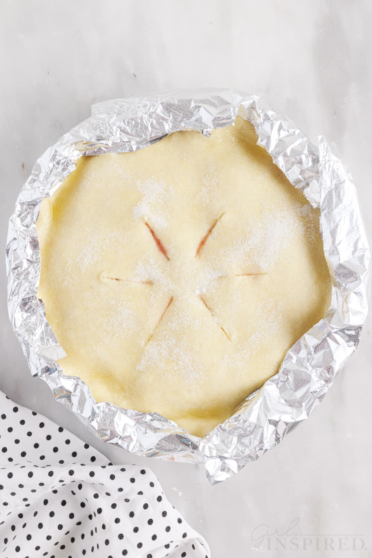 Overhead view of Fresh Peach Pie with its edges covered in foil.