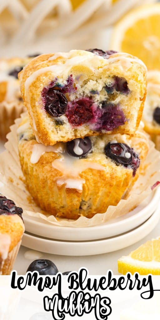 Lemon Blueberry Muffins stacked on each other paper pulled back from the bottom one and a bite taken from the top one.