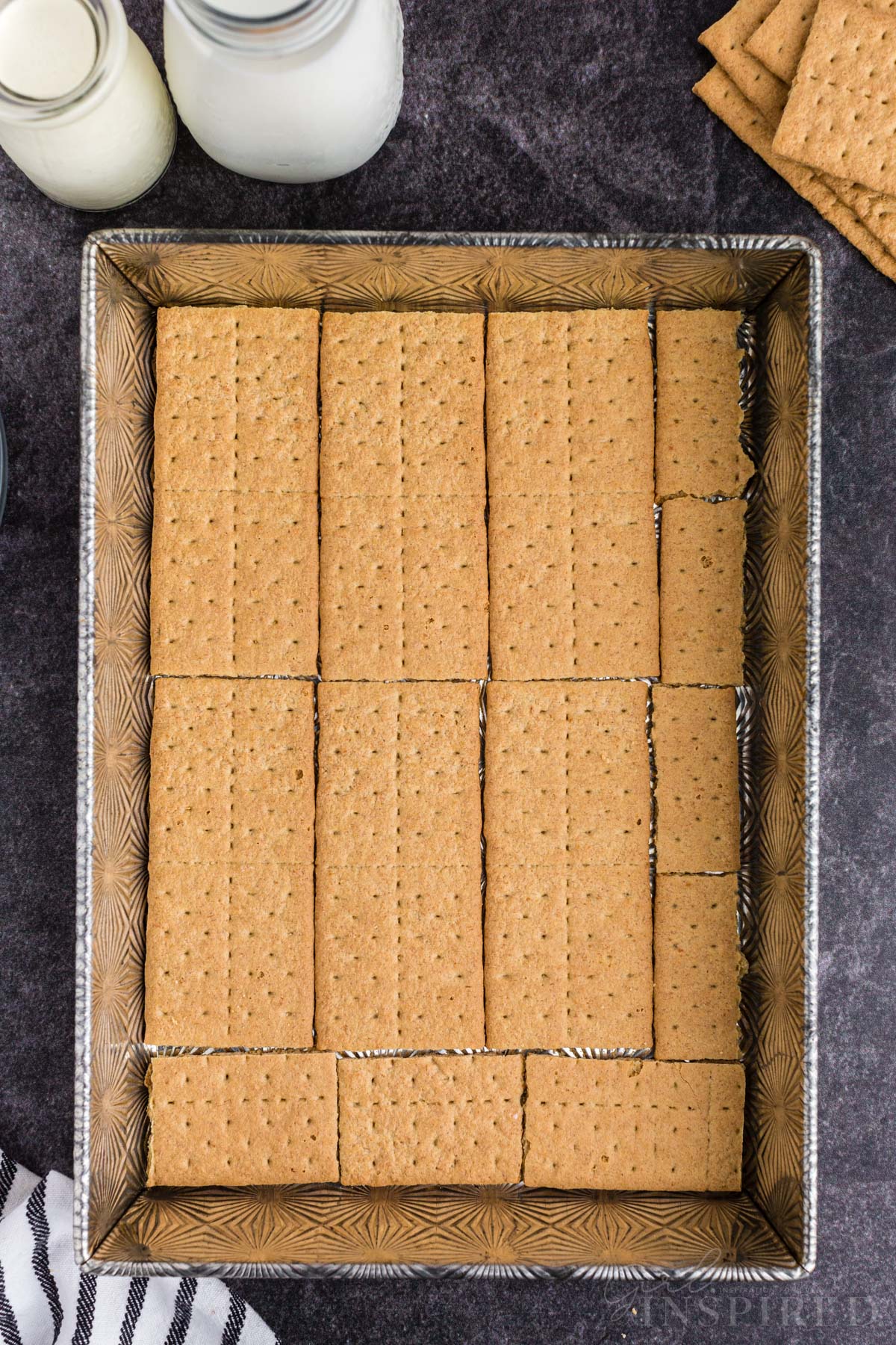 Bottom layer of Graham crackers spread evenly in a casserole dish.